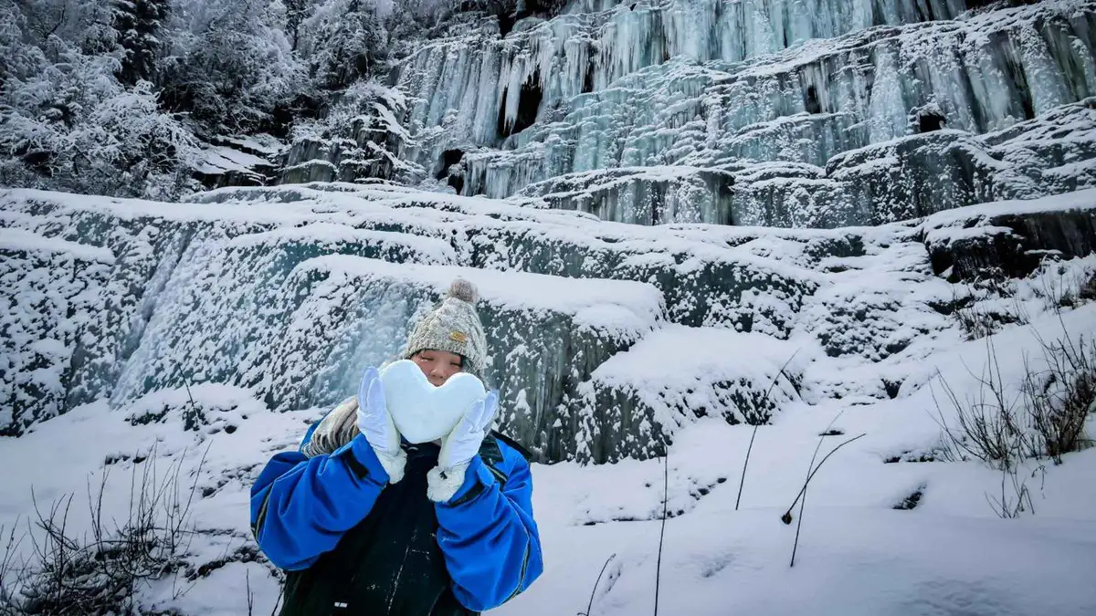 Small group on the snowy descent into Korouoma Canyon on a frozen waterfalls hike from Rovaniemi, Finnish Lapland